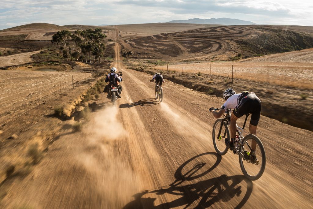 The TV camera gets footage of Jaroslav Kulhavy and Christoph Sauser (Investec-Songo-Specialized) bombing down the descent