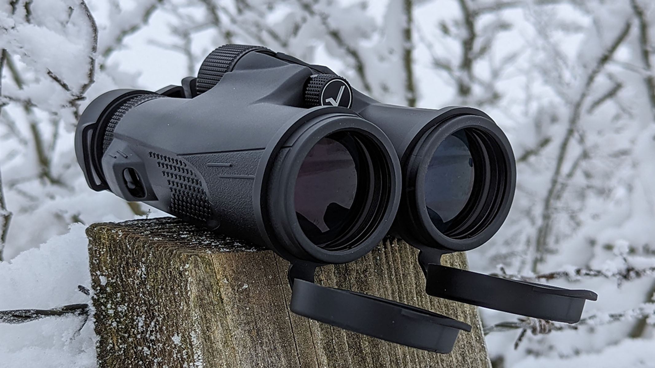 Front view of binoculars on a snowy post