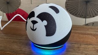 The side view of Amazon Echo Dot Kids smart speaker on a wooden table with a patterned background