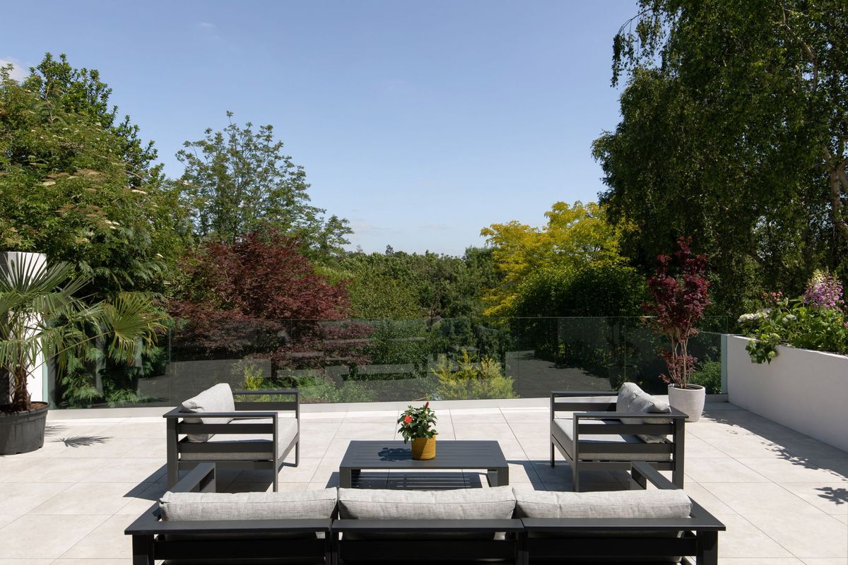 The garden of the property has a patio overlooking a pond
