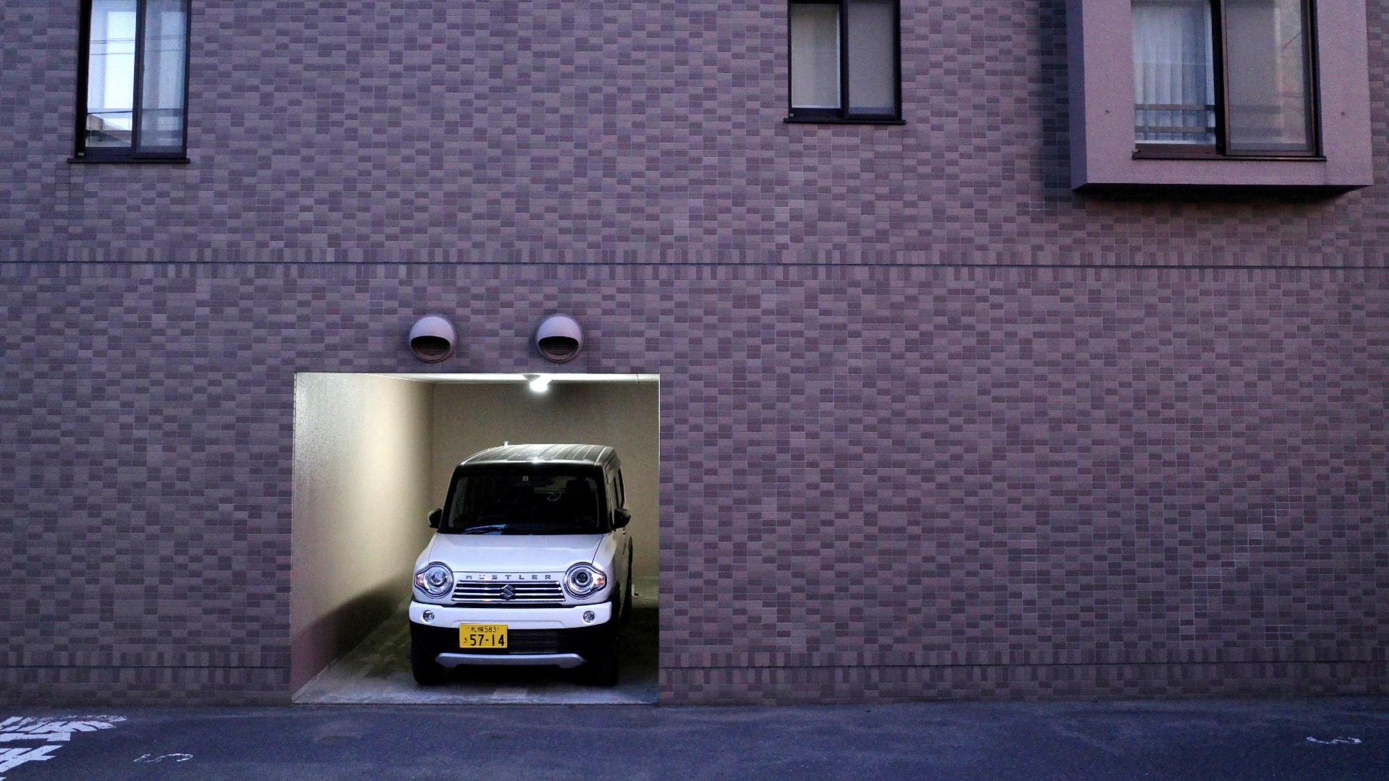 A Japanese kei or micro car sits in a garage in Sapporo, Japan.