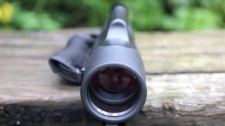 A monocular on a wood plank.