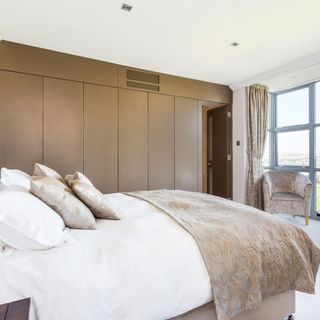 bedroom with wardrobes and pillows on bed