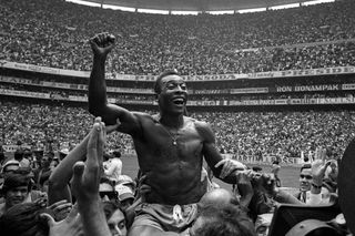 Brazil icon Pele, shirtless, is carried as he celebrates winning the 1970 World Cup final against Italy at the Estadio Azteca in Mexico City