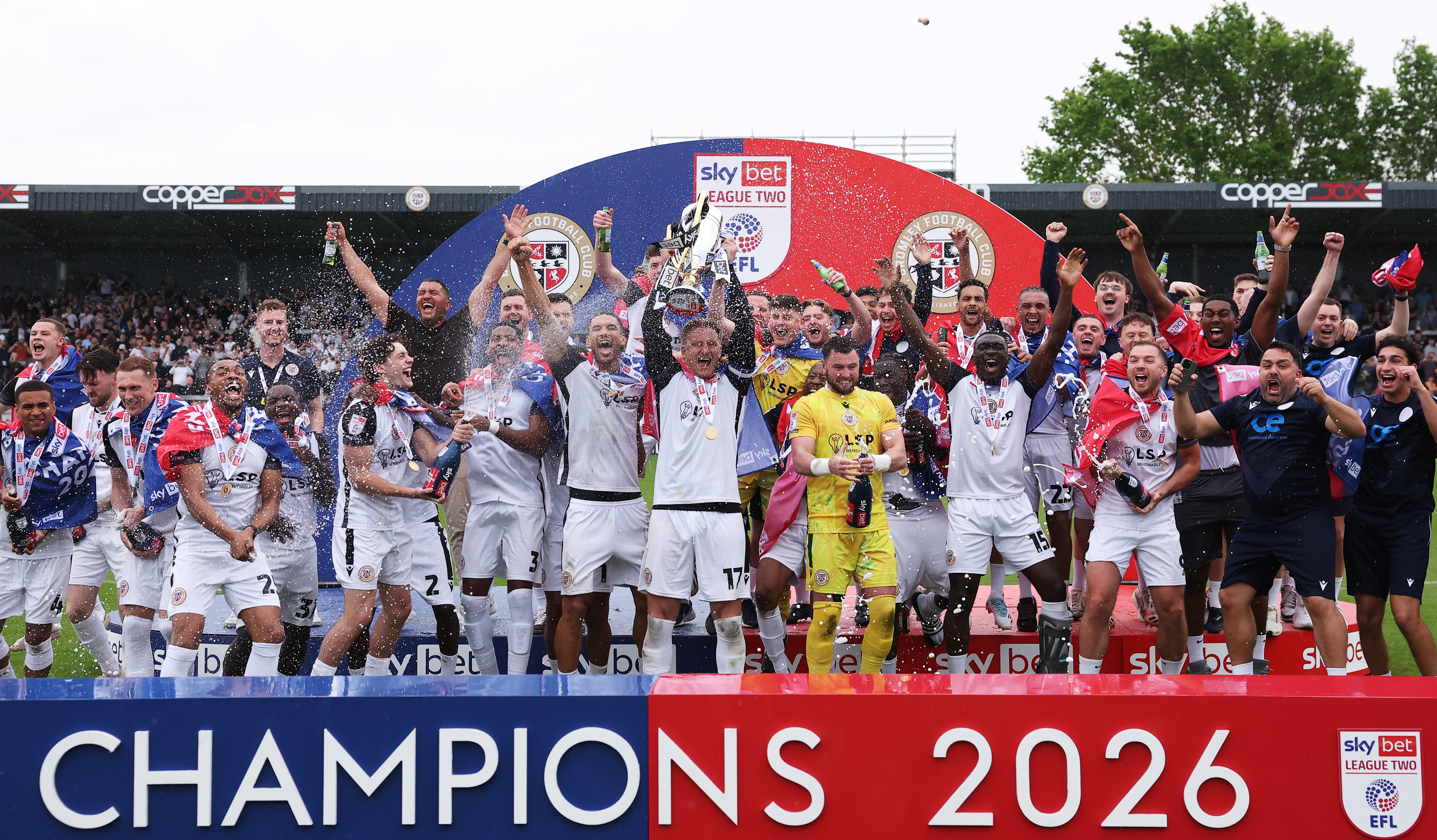 Byron Webster of Bromley lifts the Sky Bet League Two Winners' trophy following victory in the Sky Bet League Two match between Bromley FC and Walsall