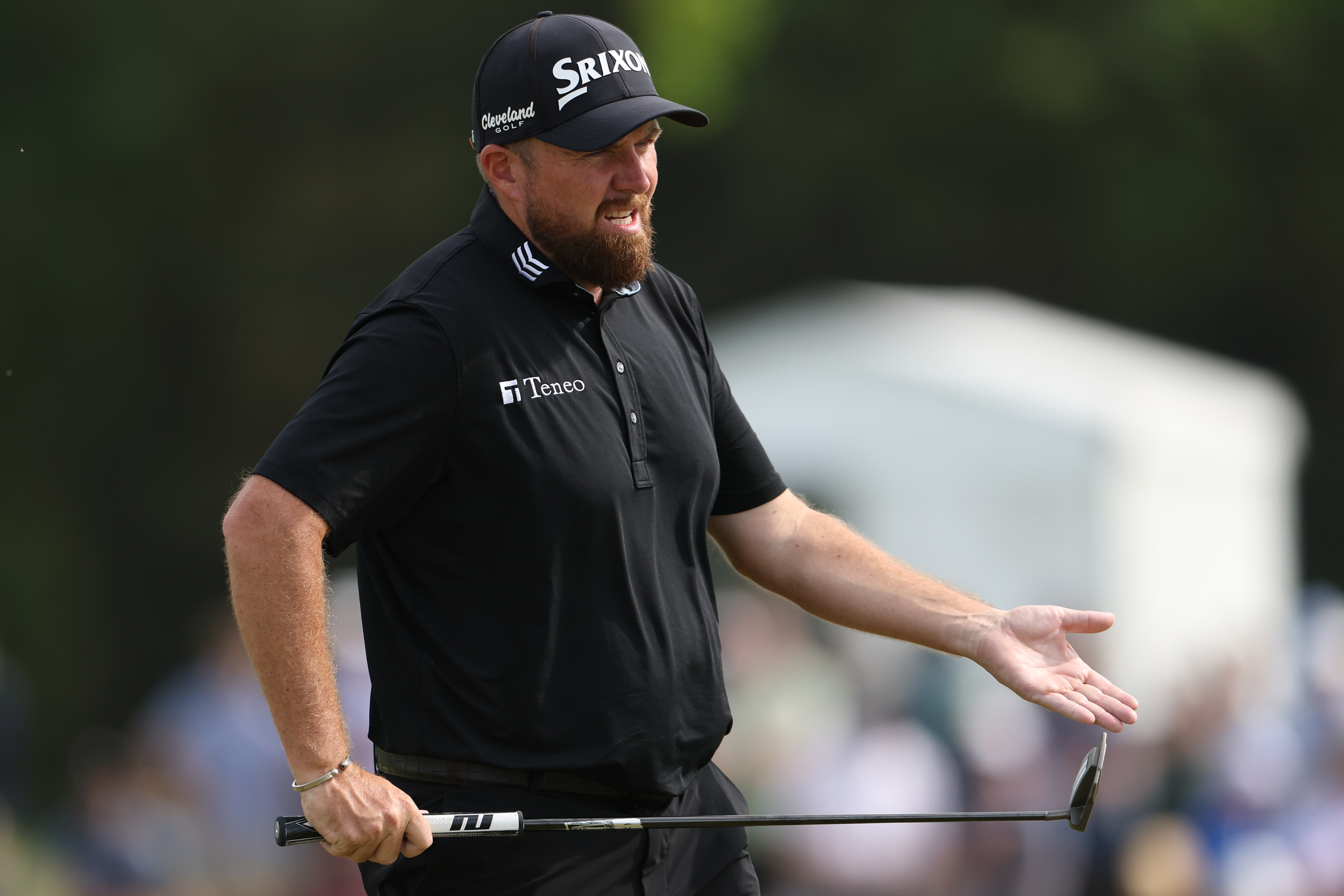 Shane Lowry wipes his putter head