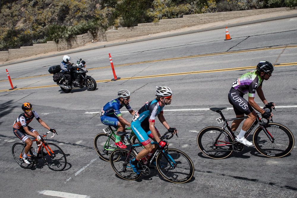 Four riders go up the road