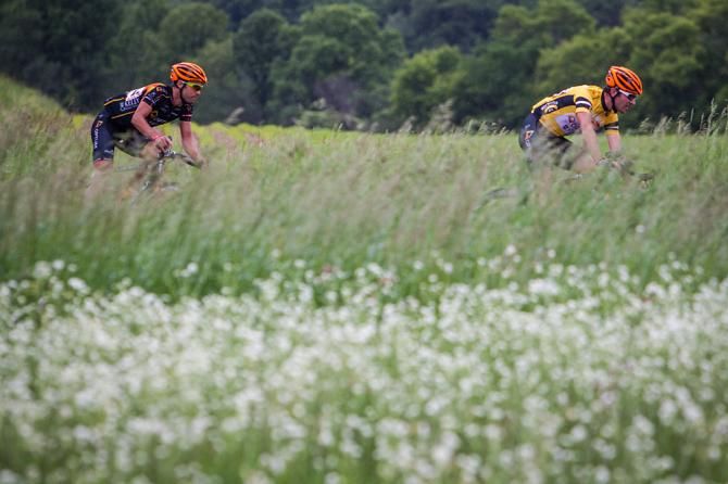 Ryan Anderson (Optum) and teammate Jessie Anthony ride through Wisconsin fields