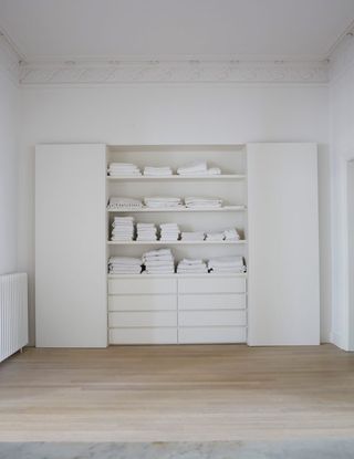 bathroom storage ideas - a white bathroom with built-in cupboard
