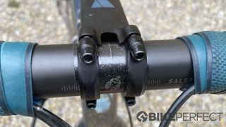 A close detail shot of the Salsa Cowbell Carbon gravel handlebar clamping area