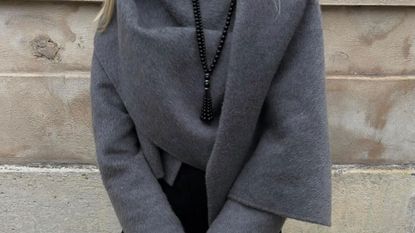 @signeemilieolesen outfit closeup in grey jacket with scarf detail and black tassel beaded necklace