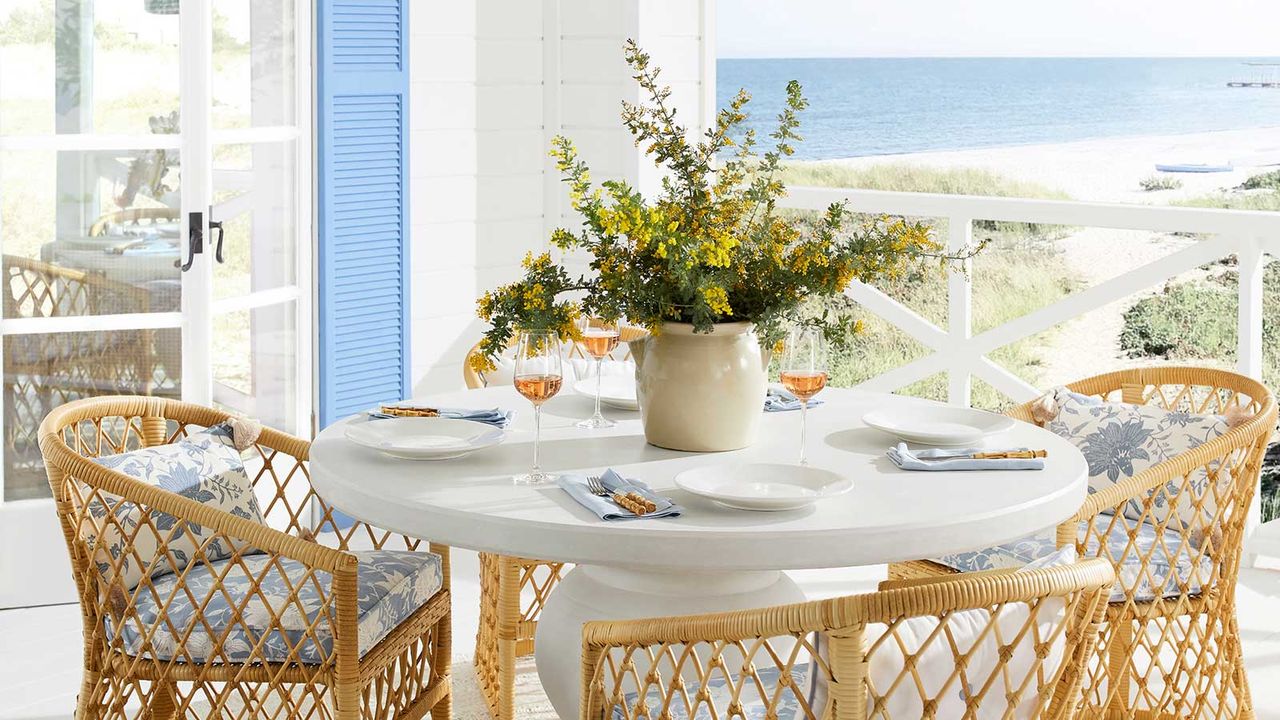 outdoor dining table with vase of flowers