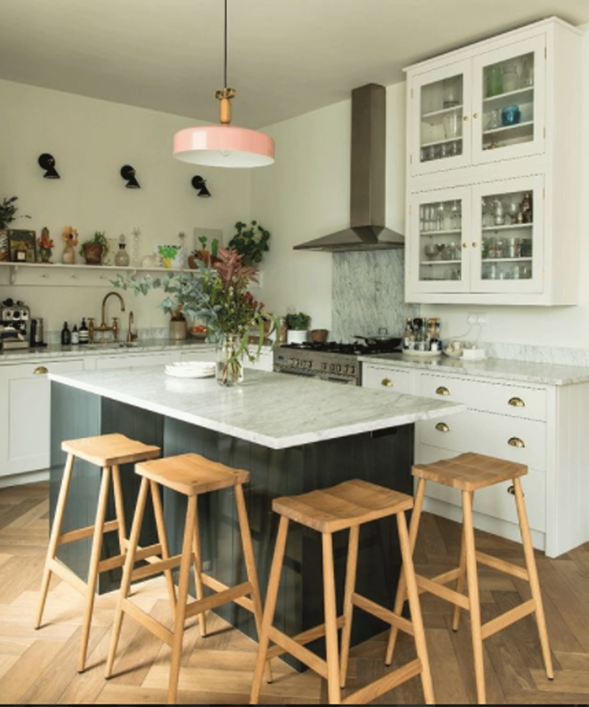 White kitchen with small island and four wooden stools