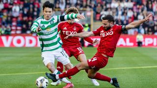 Celtic's Hyunjun Yang and Aberdeen's Graeme Shinnie battle for the ball.