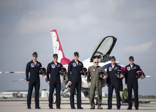 Apollo 11 astronaut Buzz Aldrin (in gray suit) poses with members of the USAF Thunderbirds. Aldrin participated in a flight with the Thunderbirds on April 2.