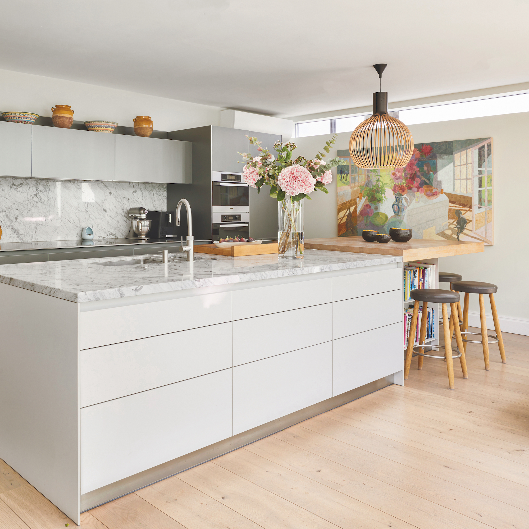 modern white kitchen with german cabinets and island with basin and tap