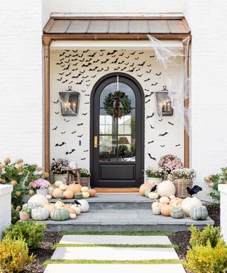 Shea McGee's front porch for Halloween with bat silhouettes