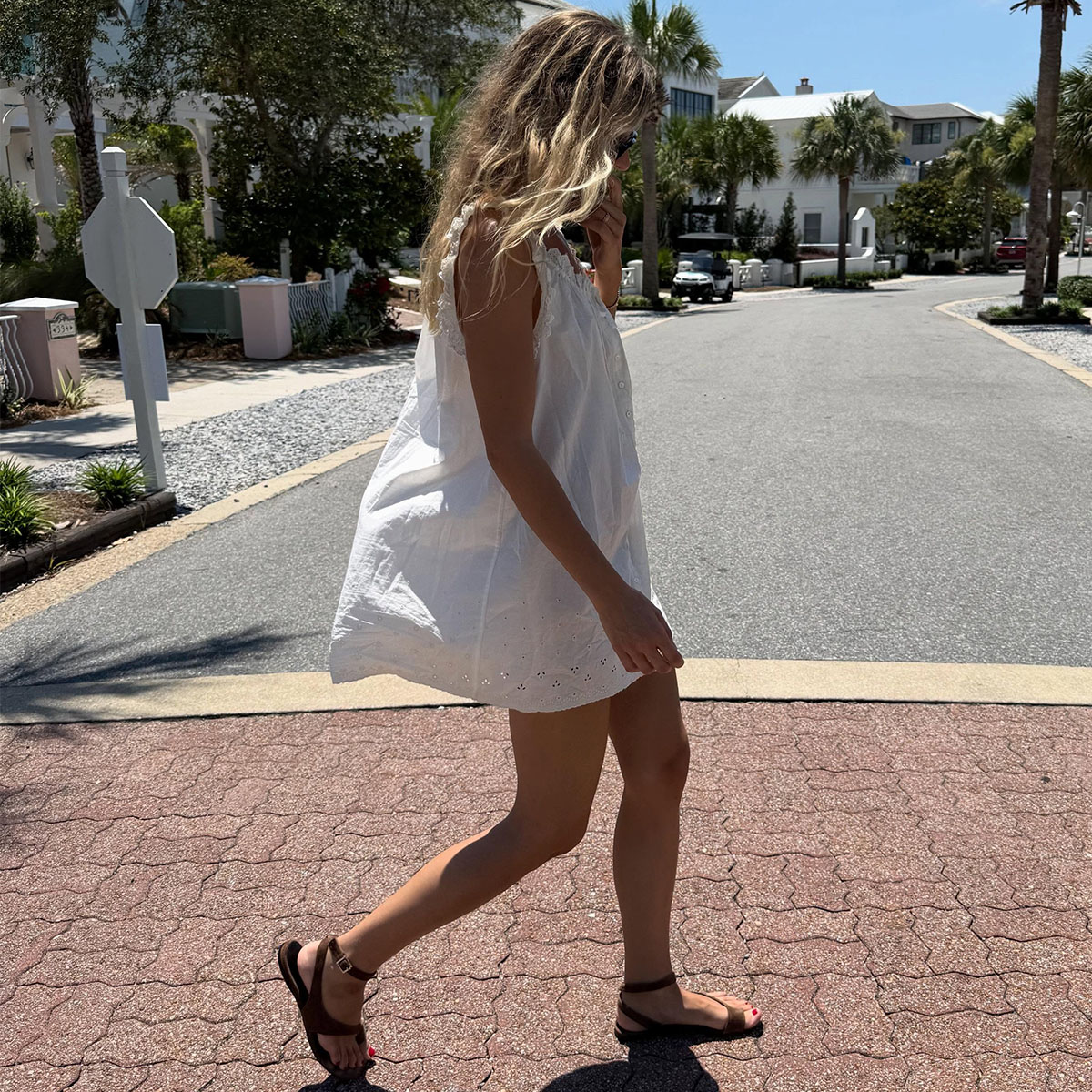 A woman in a white summer mini dress