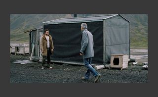 Two men standing near the tent