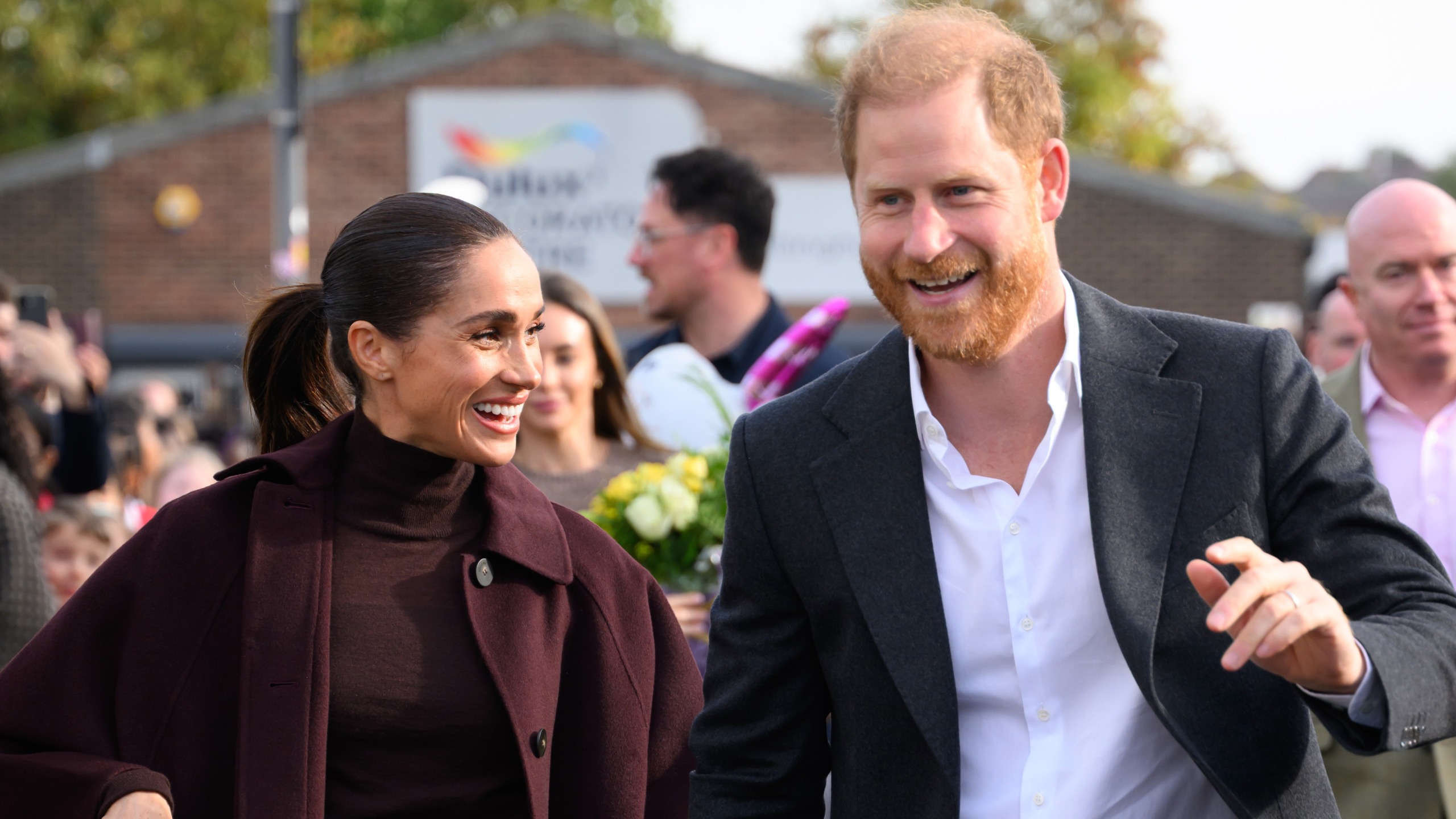 Prince Harry, Duke of Sussex and Meghan, Duchess of Sussex greet well-wishers as they arrive at the Community Recording Studio (CRS)