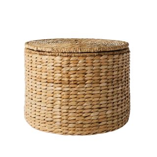 A round woven storage ottoman