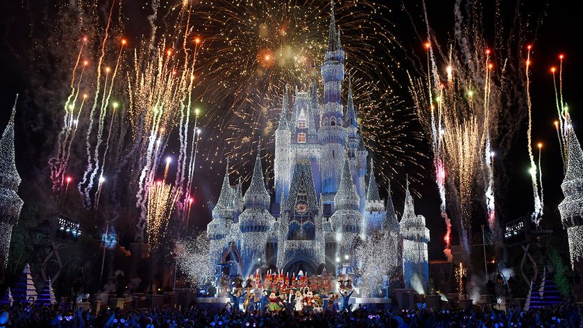 Image of the castle lit up at night and fireworks at Walt Disney Resort in Orlando, Florida. 