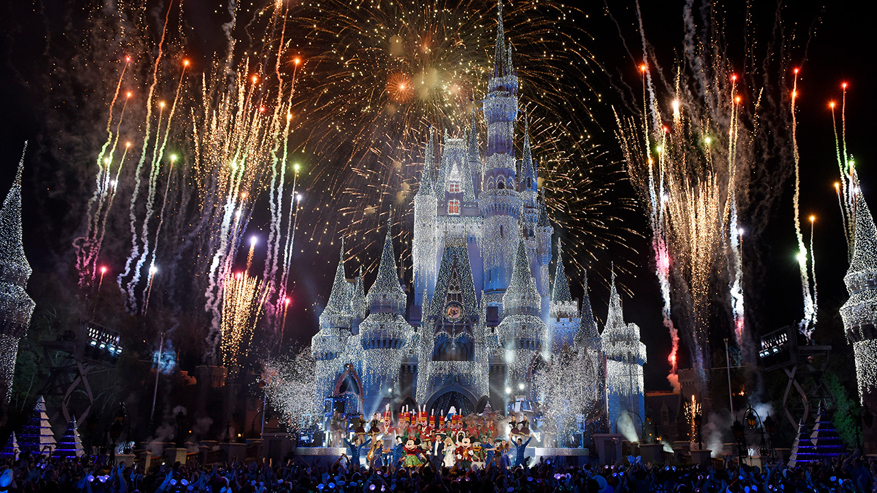 Image of the castle lit up at night and fireworks at Walt Disney Resort in Orlando, Florida. 