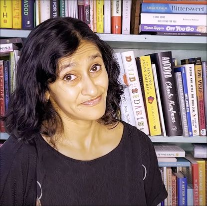 Aparna nancherla in front of her bookshelf 