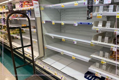 Emoty supermarket shelves next to a sign saying 'Eggs'