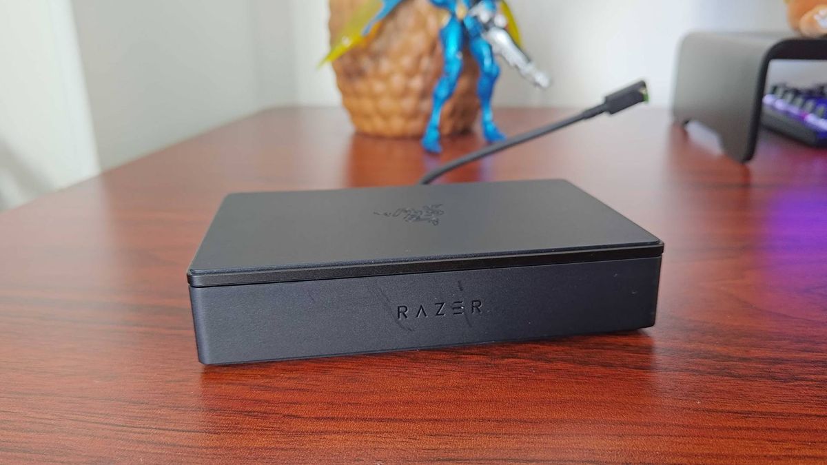 Razer Handheld Dock sitting on woodgrain desk.