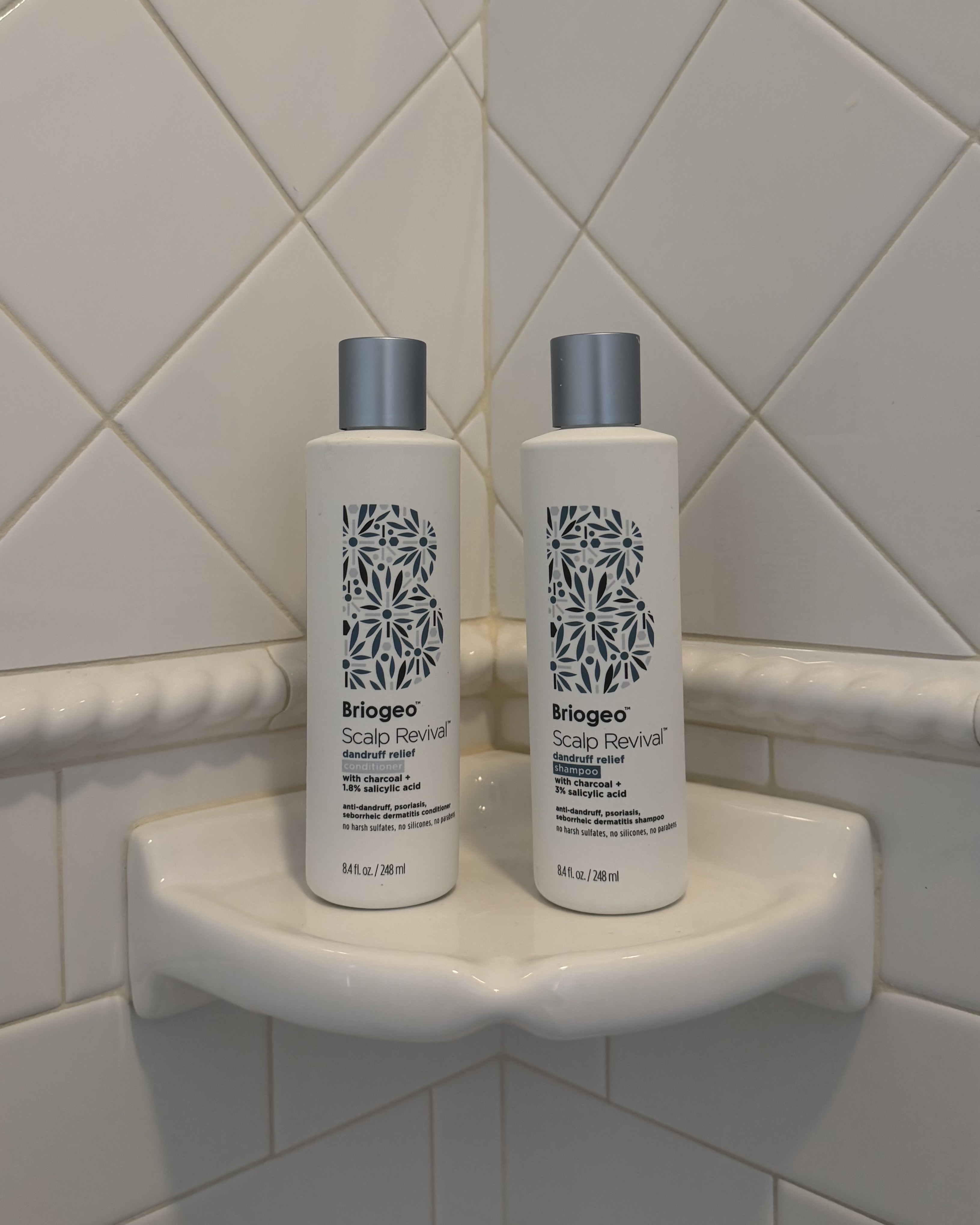 An image of the Briogeo Scalp Revival Dandruff Relief Shampoo and Conditioner in Brascia's shower.