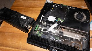 A photo of the PS4 showing the power supply removed and the heatsink exposed