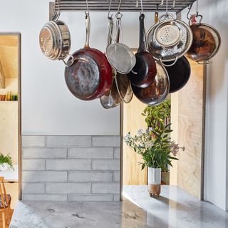 Saucepans hanging from a kitchen ceiling