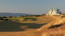 The 9th hole and clubhouse at Cabot Highlands Castle Stuart