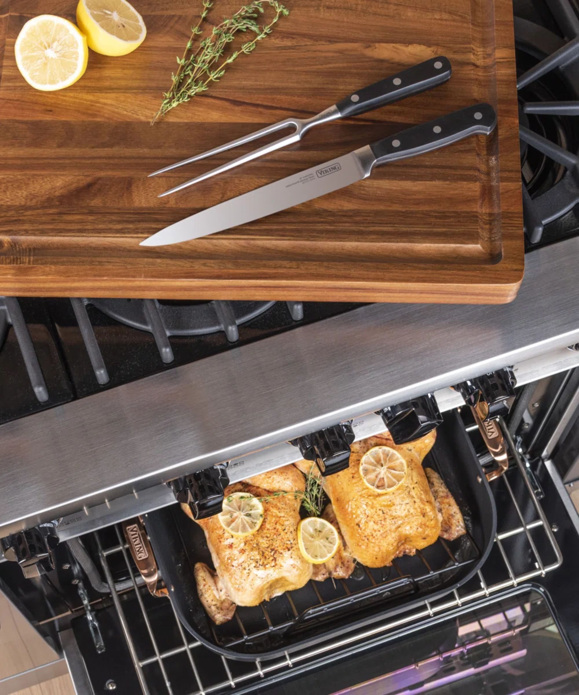 Oven with turkey roasting pan inside and wooden board with carving knives on the stovetop