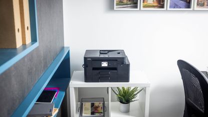 Brother MFC-J4550DW inkjet printer pictured on a desk in a home office.