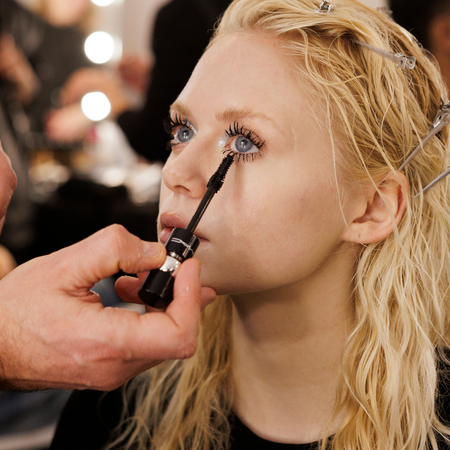 Make-up artist applying mascara to a model's bottom lashes - Best mascara for bottom lashes