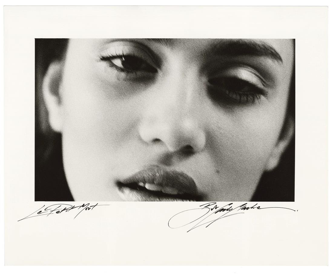 A tightly cropped black and white close-up of a woman's face looking down, with the print signed and titled &amp;quot;Le Petit Mort&amp;quot; beneath it.