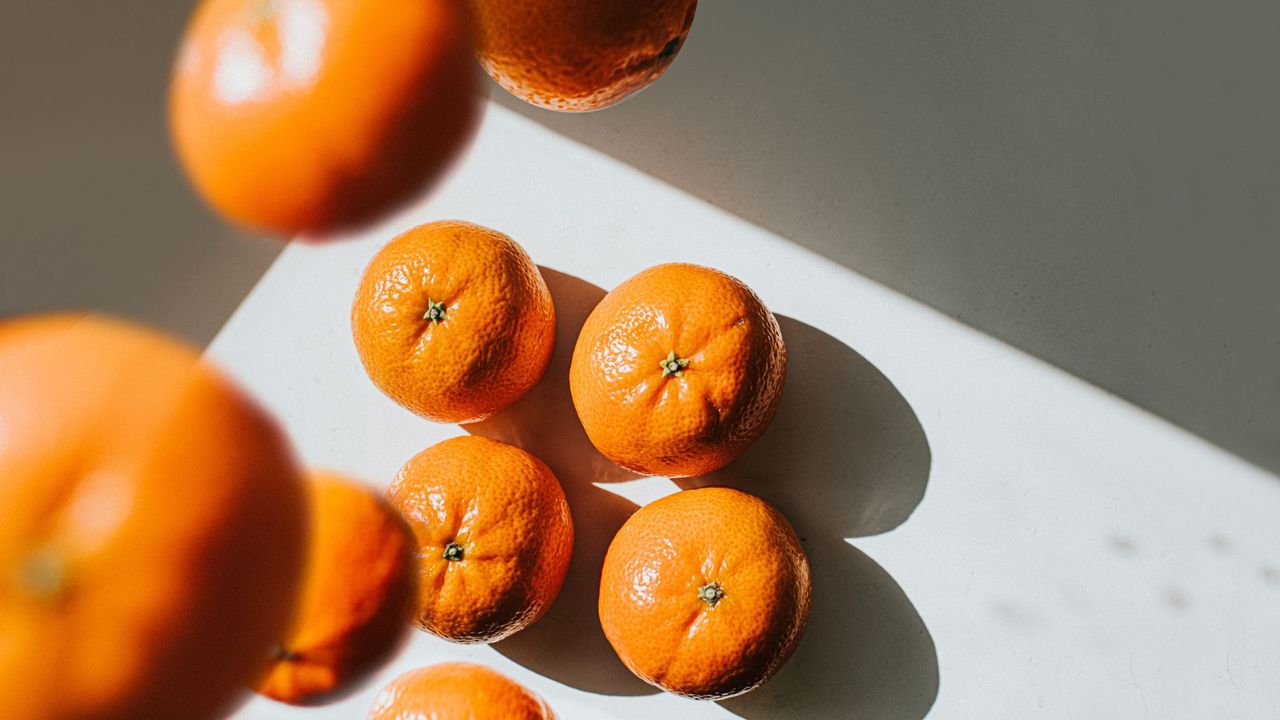 Collection of oranges falling onto kitchen