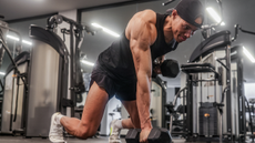 male personal trainer weight training in the gym