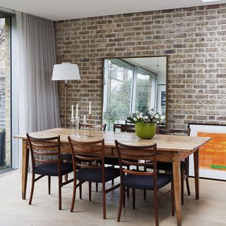 Dining room with brick wall and table and chair
