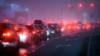 A foggy night view of a traffic jam