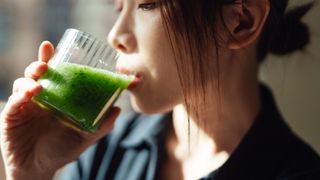 Woman drinking greens juice