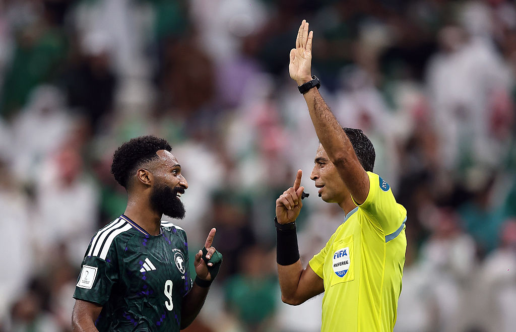 Referee Amin Mohamed Omar and Feras Albrikan of Saudi Arabia interact during the FIFA Arab Cup 2025 Quarter Final match between Palestine and Saudi Arabia at Lusail Stadium in Lusail City, Qatar