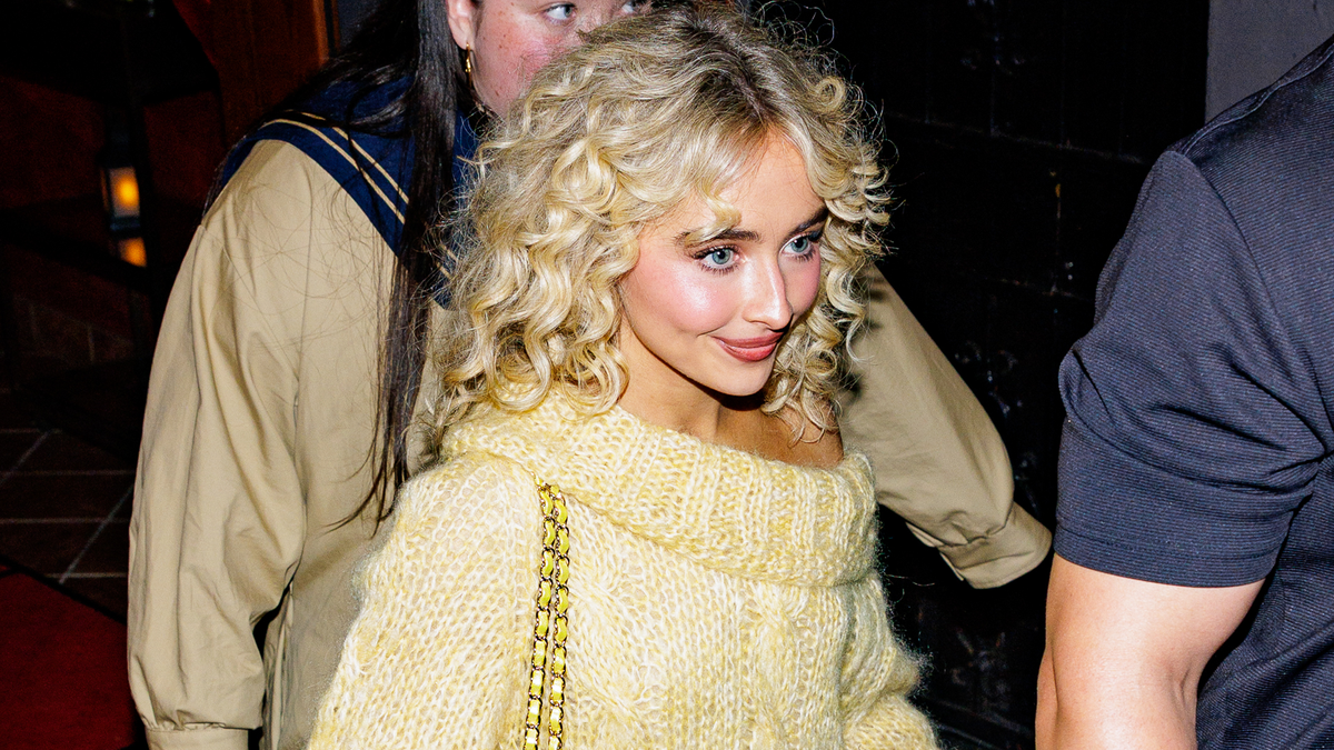 sabrina carpenter rocks butter yellow off-the-shoulder sweater dress Sabrina Carpenter Pairs a Butter Yellow Sweater Dress With a Chanel Bag