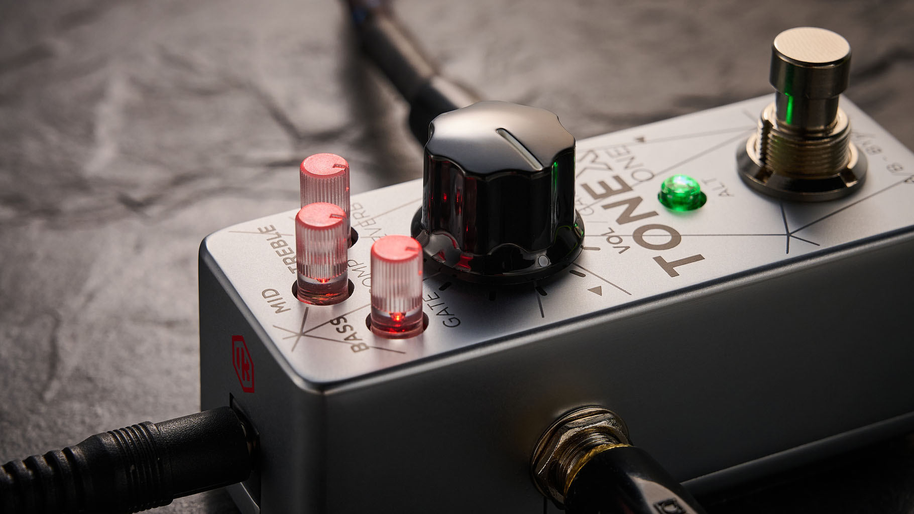 IK Multimedia Tonex One Bass: the mini-pedal offers amp modelling and heaps of tone options and is here photographed against a slate floor.