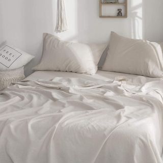 Linen sheets on bed