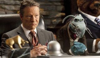 The Muppets Chris Cooper tenting his hands evil-like