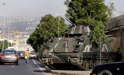 An armored tank sits outside the official residence of the French ambassador to Lebanon in Beirut