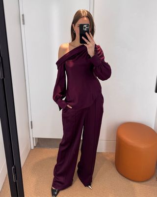 @streetchloe wearing a plum satin blouse, matching trousers and black slingback heels